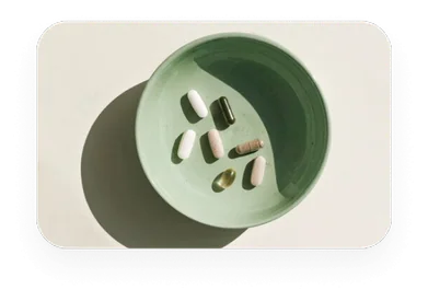 A sage bowl of vitamin capsules from the nature moodboard
